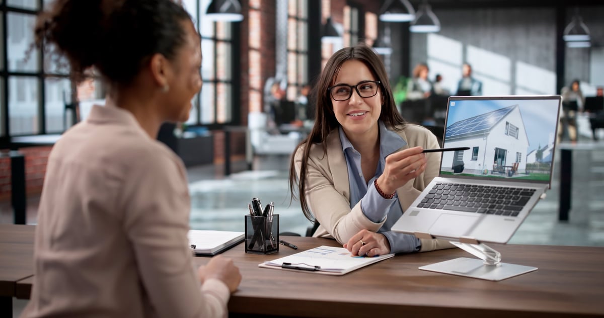 An agent discussing market conditions with a homebuyer